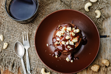 chocolate pancake with bananas, nuts and chocolate sauce