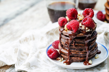 chocolate pancake with bananas, raspberies, nuts and chocolate s