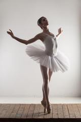 Ballerina posing tiptoe in the studio