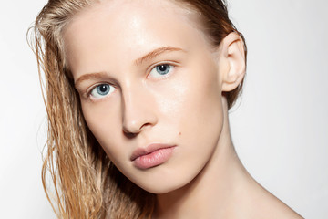 Woman with blonde hair wet without makeup