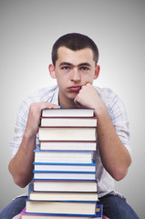 Student with lots of books on white