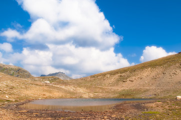 landscape of an alpine lake with cloudy sky