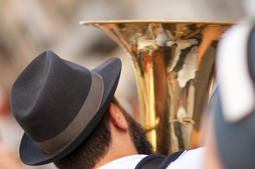 man plays his tuba during an outdoor party