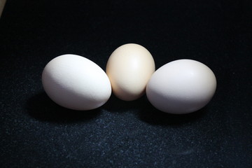 3 eggs isolated on black background