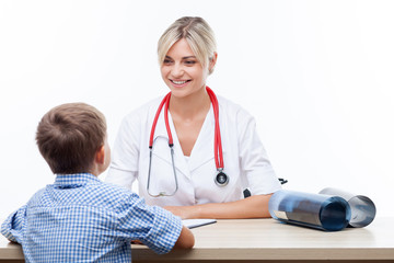 Cheerful young female pediatrician is serving her patient