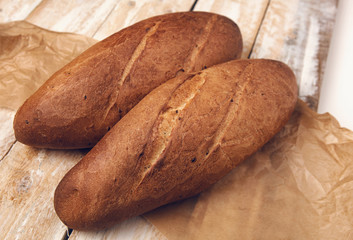Two loafs of handmade bread on a wooden table