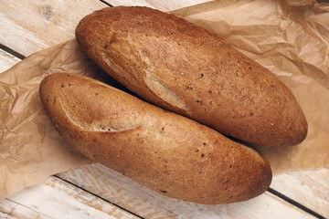 Two loafs of handmade bread on a wooden table