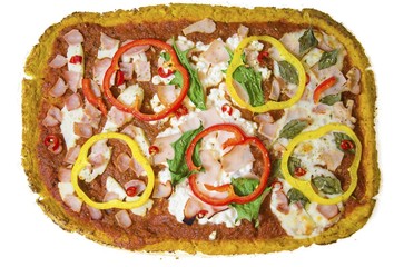Top view of rectangular oven baked cauliflower pizza crust with halloumi,cottage,mozzarella cheese,spinach,turkey,ham,peppers,chili,basil,tomato sauce isolated on white background.A healthy snack