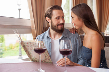 Beautiful young man and woman are resting in cafe