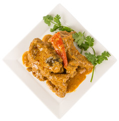 Lamb curry on a white plate over white background