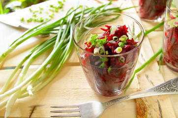 Fresh beetroot salad with bunch-onion in glasses