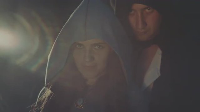 The guy with the girl in a hooded cloak with magical at night