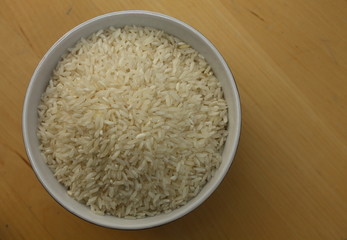 bowl of white rice on wooden table.