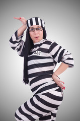 Prisoner in striped uniform on white