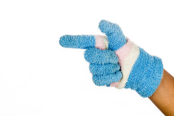 Hand in blue winter glove pointing direction against white background