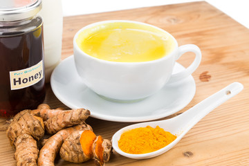 Turmeric roots with milk and honey drinks for beauty and health.