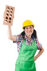 Female workman in green overalls holding brick isolated on white
