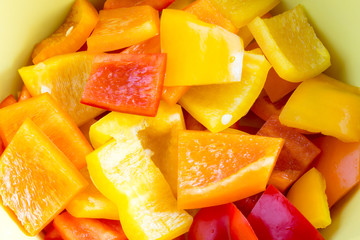 Small bell pepper pieces in a bowl in different colours, yellow, red and orange