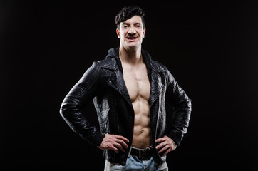 Muscular man posing in dark studio