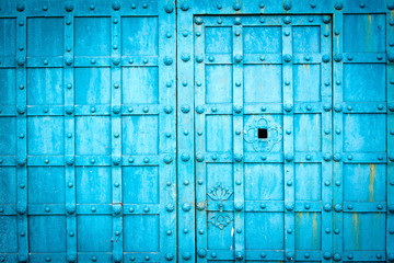 Blue metal door gate texture witn checkered pattern