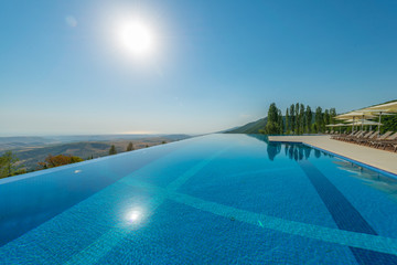 Fototapeta premium Infinity pool on the bright summer day