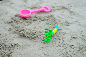 Fototapeta na wymiar Colorful beach toys on sand