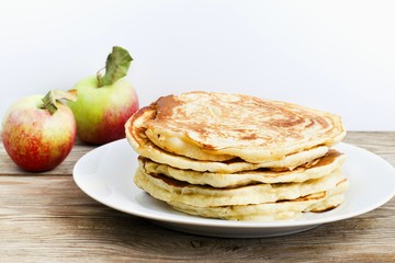 pancakes with apple  on wooden table