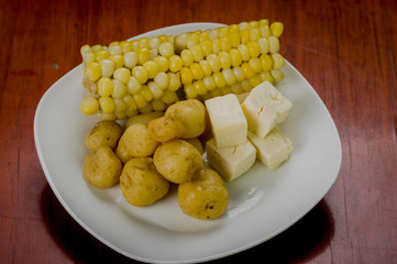 Closeup freshly prepared corn, balls of green banana and pieces