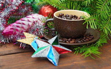Branch of green fir tree with christmas toys and cup of coffee