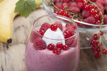Smoothie of banana, raspberry and red currant decorated ice crea