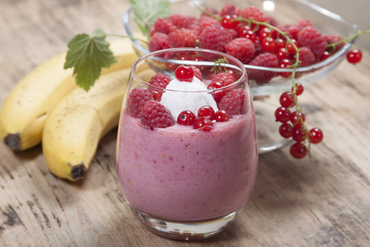 Smoothie of banana, raspberry and red currant decorated ice crea