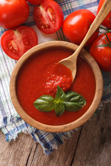 Fresh tomato sauce in a wooden bowl closeup. vertical top view
