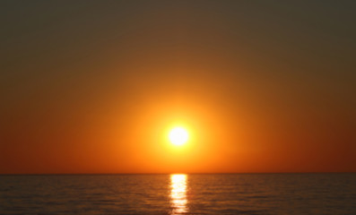 Fototapeta na wymiar Unfocused sunset above the sea.