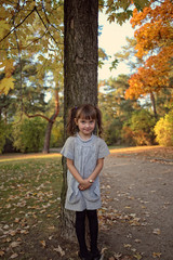 Young girl in a sweater on a walk in the autumn day