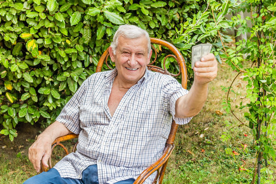 octogenarian elder play cards in the garden