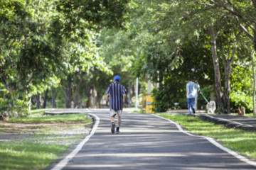 Blur image of man walking in the park