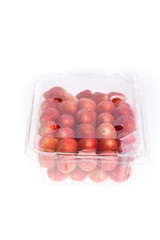 red ripe strawberry in plastic box of packaging, isolated