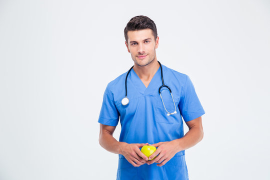 Portrait Of A Handsome Male Doctor Holding Apple