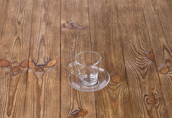 Empty cup with dish isolated on wooden texture