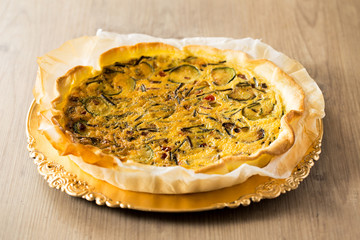 Asparagus quiche on a wooden table.