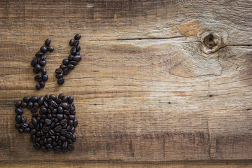 Roasted coffee beans placed in the shape of a cup
