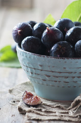 Red sweet figs on the wooden table