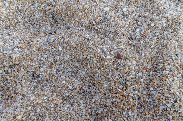 Naturally rounded gravel at sea shore, nature background texture