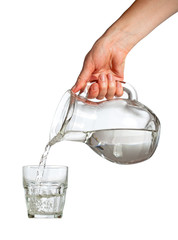 Hand pouring water from glass pitcher