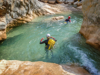 People in the water of a canyon in summer, canyoning in Barranco Oscuros, Sierra de Guara, Aragon,...