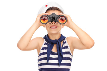 Little sailor boy looking through binoculars isolated on white b