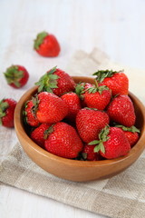Ripe strawberry in a wooden bowl