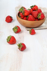 Ripe strawberry in a wooden bowl