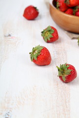 Ripe strawberry in a wooden bowl
