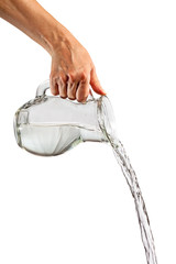 Hand pouring water from glass pitcher
